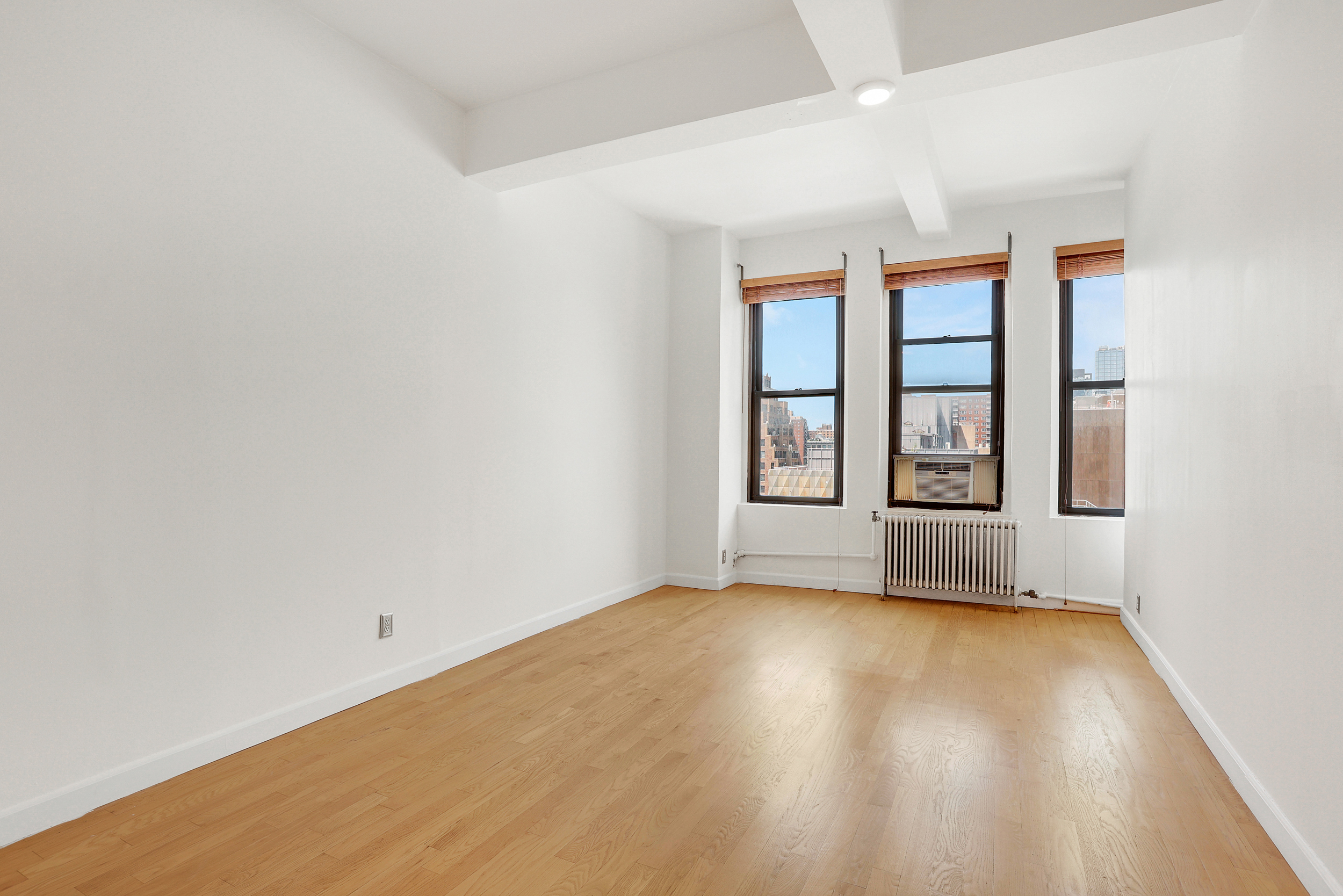 315 7th Avenue, Unit 10E Manhattan, NY 10001 - Photo 7 of 13 an empty room with windows