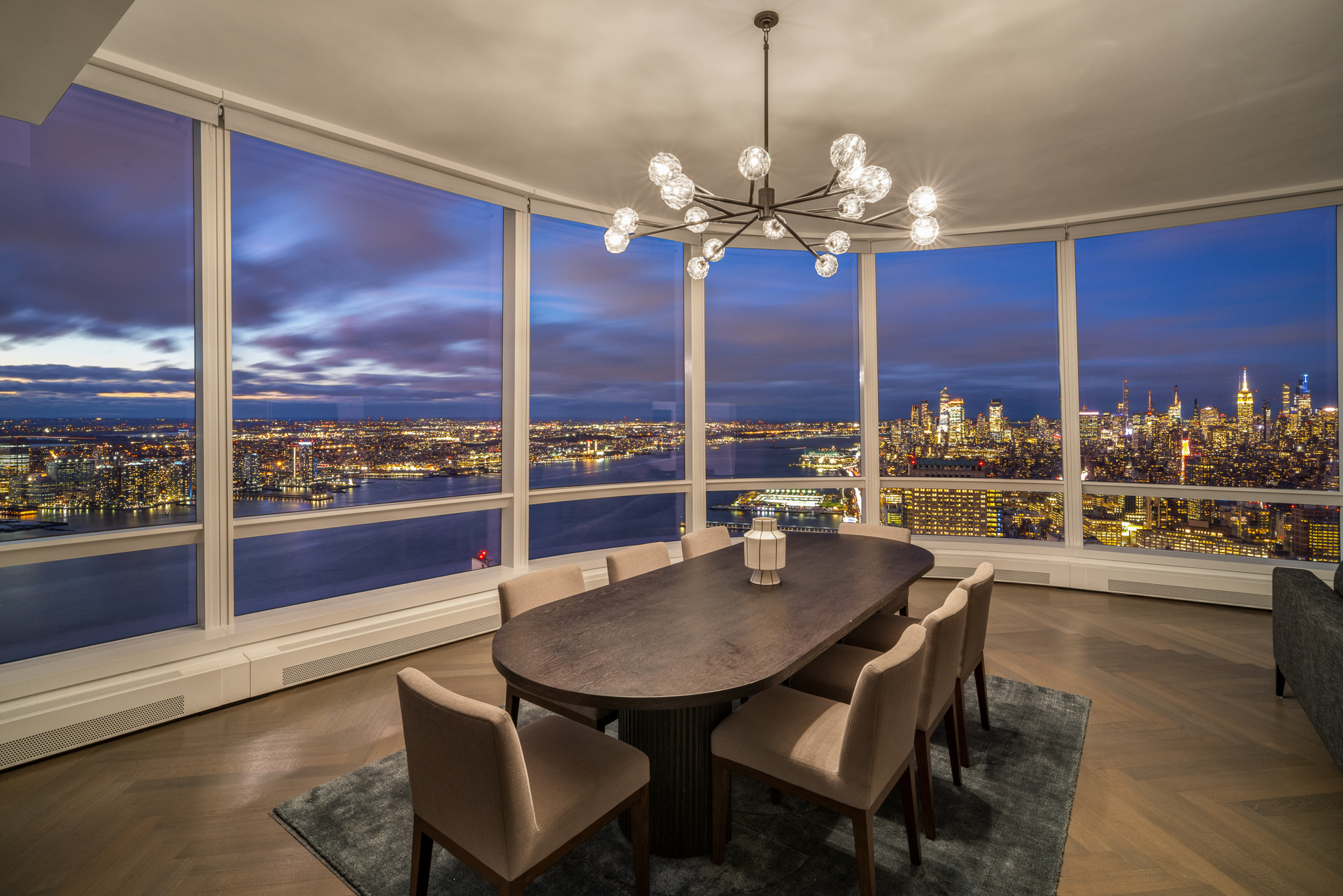 111 Murray Street, Unit 61W Manhattan, NY 10007 - Photo 33 of 35 a view of a dining room with furniture a chandelier and wooden floor