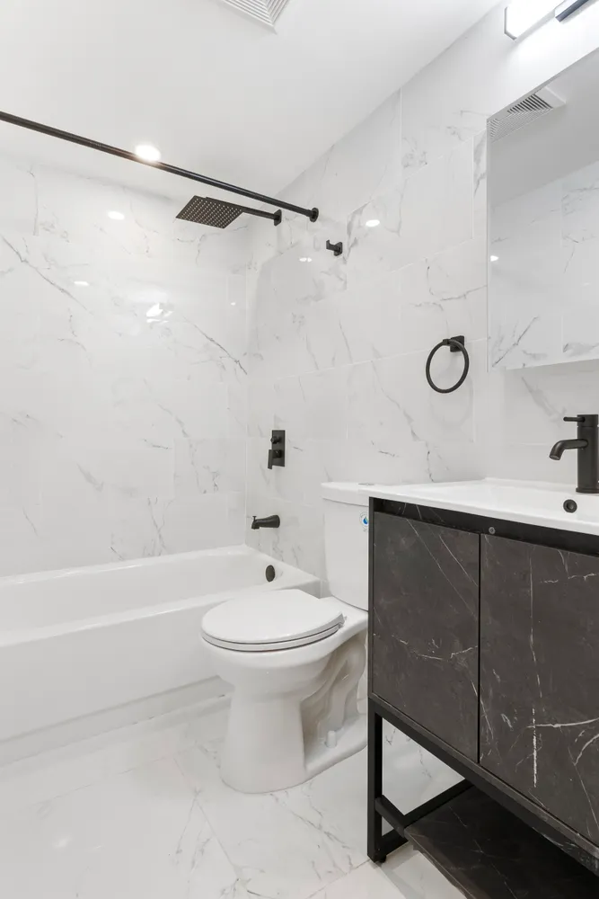 a bathroom with a sink toilet and shower