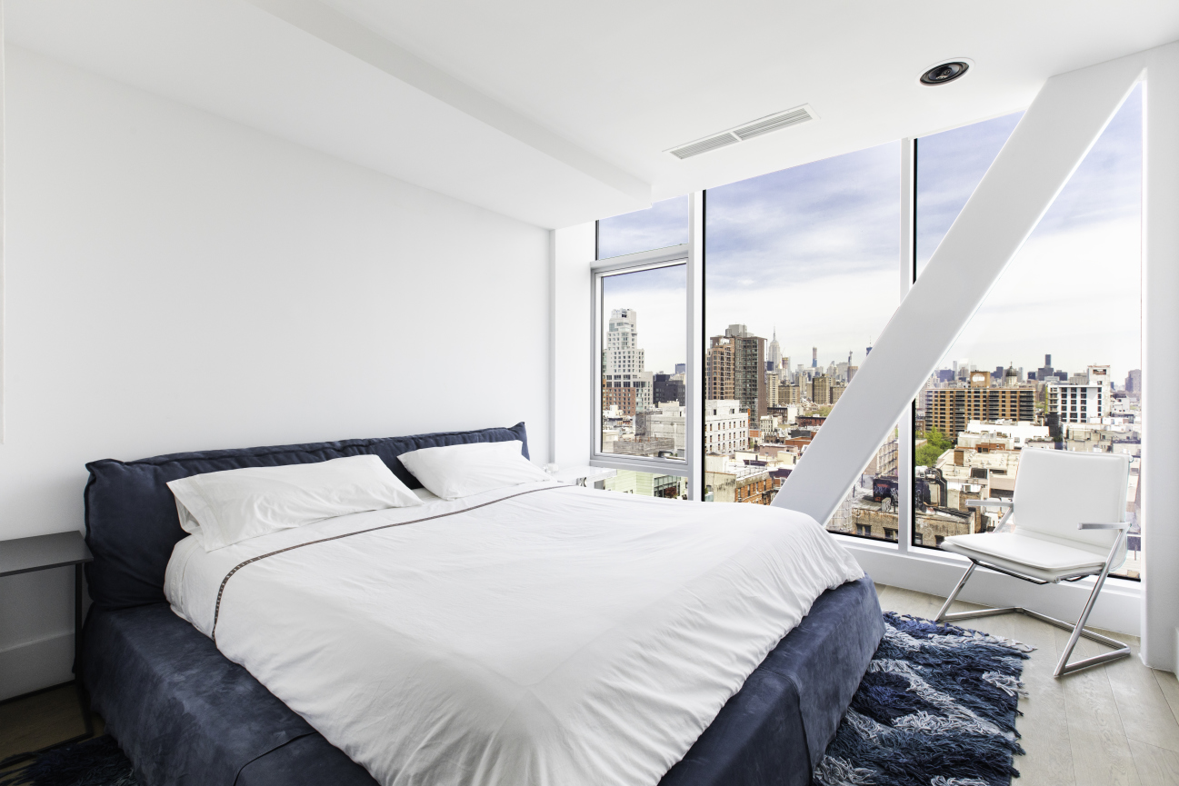 100 Norfolk Street, Unit PH Manhattan, NY 10002 - Photo 15 of 23 a bedroom with a bed and a large window