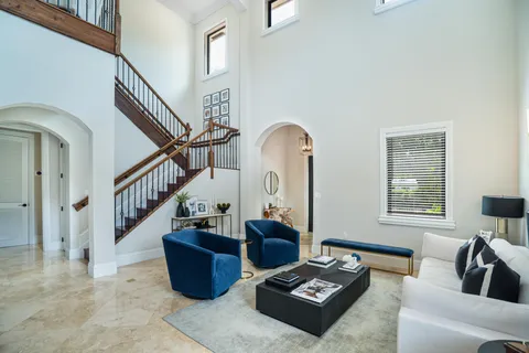 a living room with furniture and stairs