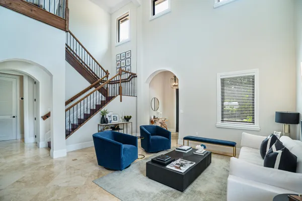a living room with furniture and stairs