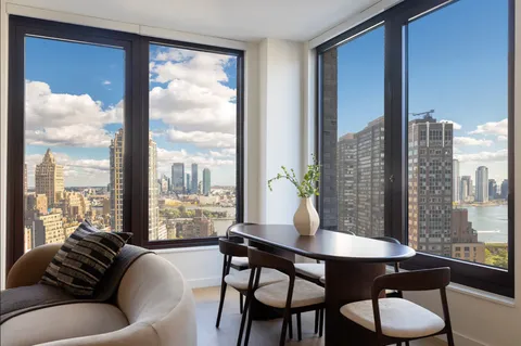 a view of a dining room with furniture window and outside view