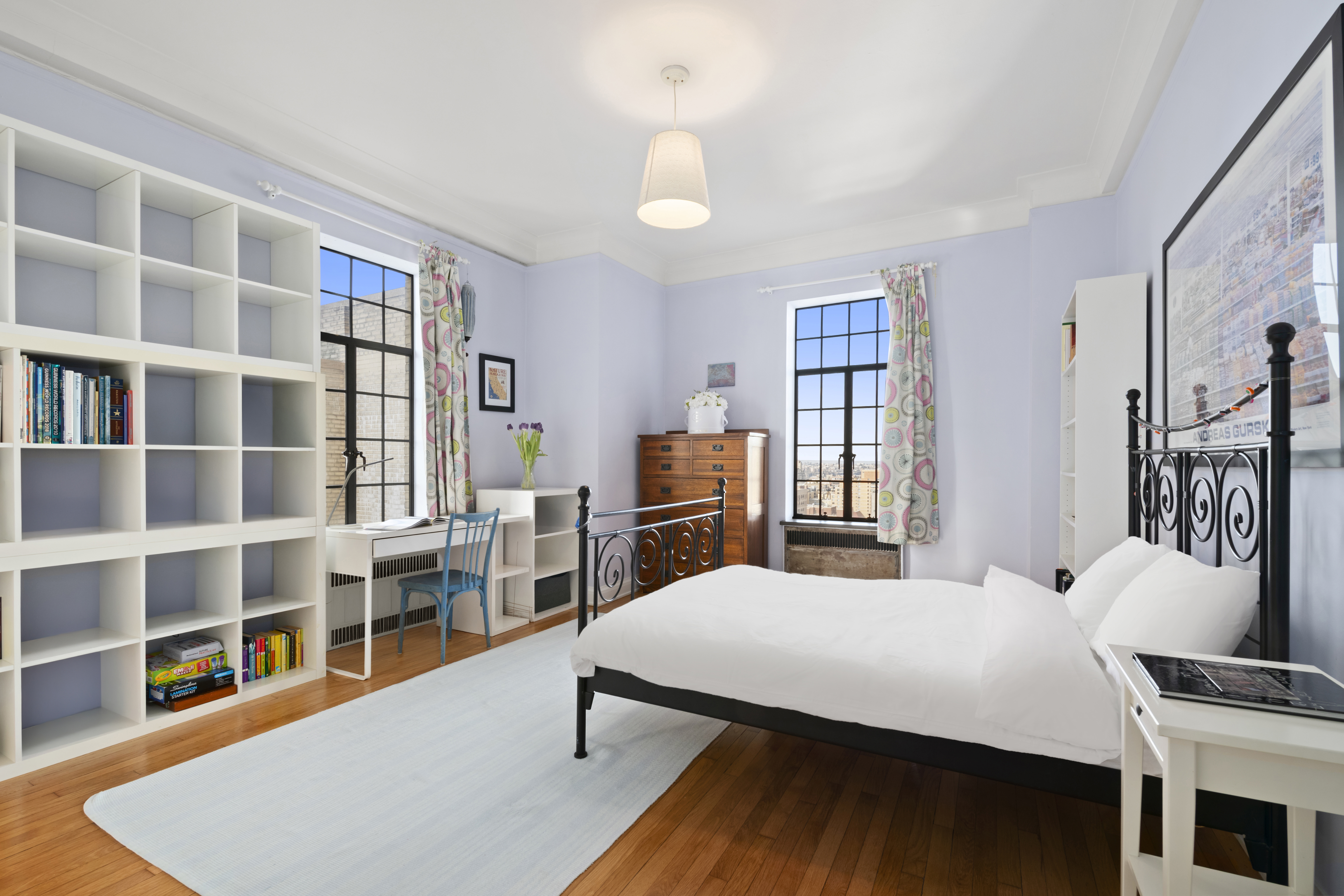300 Central Park West, Unit 21G Manhattan, NY 10024 - Photo 15 of 21 a living room with furniture a bookshelf and a window