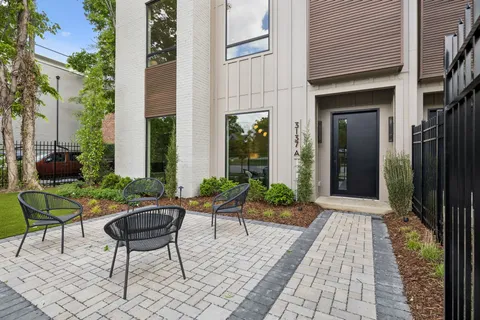 a view of a patio with couple of chairs