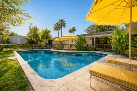 a view of swimming pool with a lounge chairs