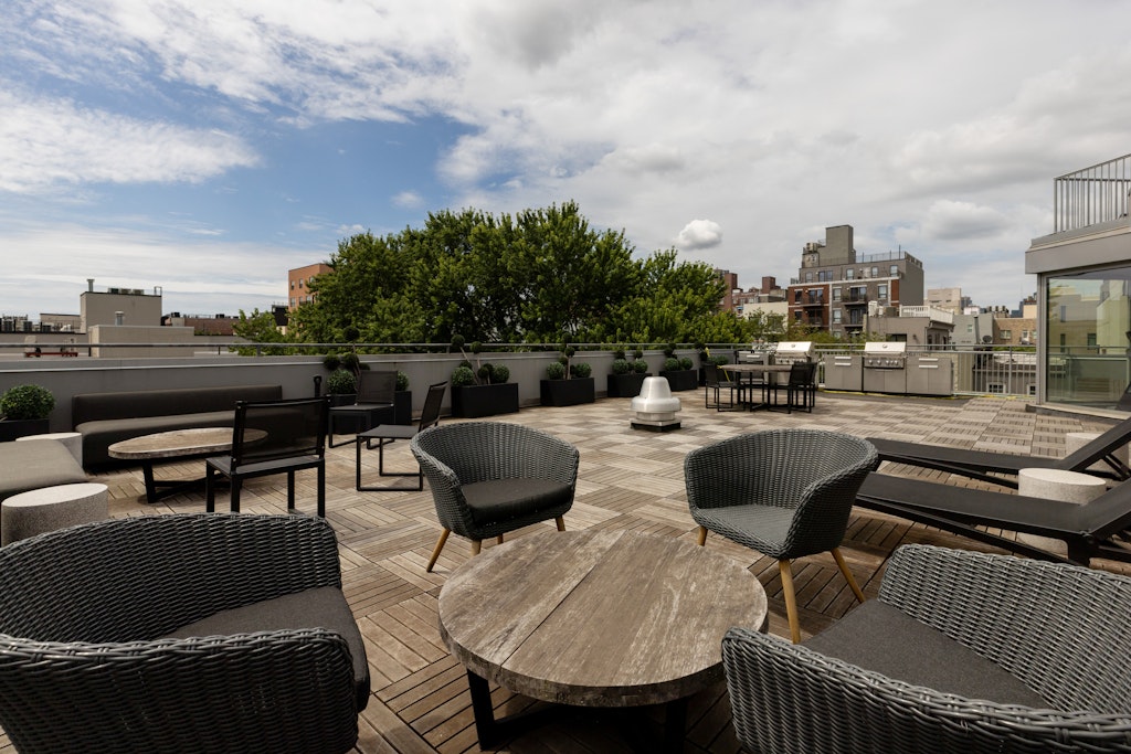 192 Spencer Street, Unit 4C Brooklyn, NY 11205 - Photo 5 of 7 a balcony with wooden floor and outdoor seating