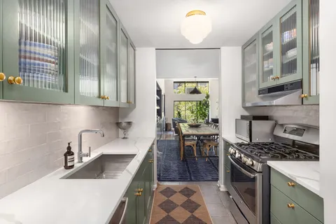 a kitchen with a sink stove and cabinets