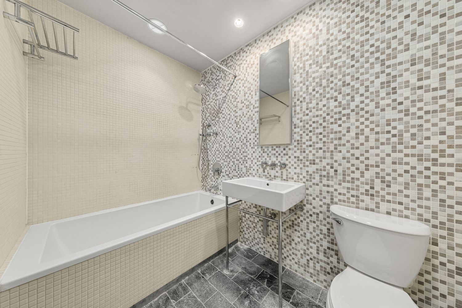 24 Beaver Street Manhattan, NY 10004 - Photo 20 of 25 a bathroom with a toilet and a bathtub