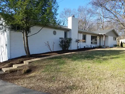 a view of house with a tree
