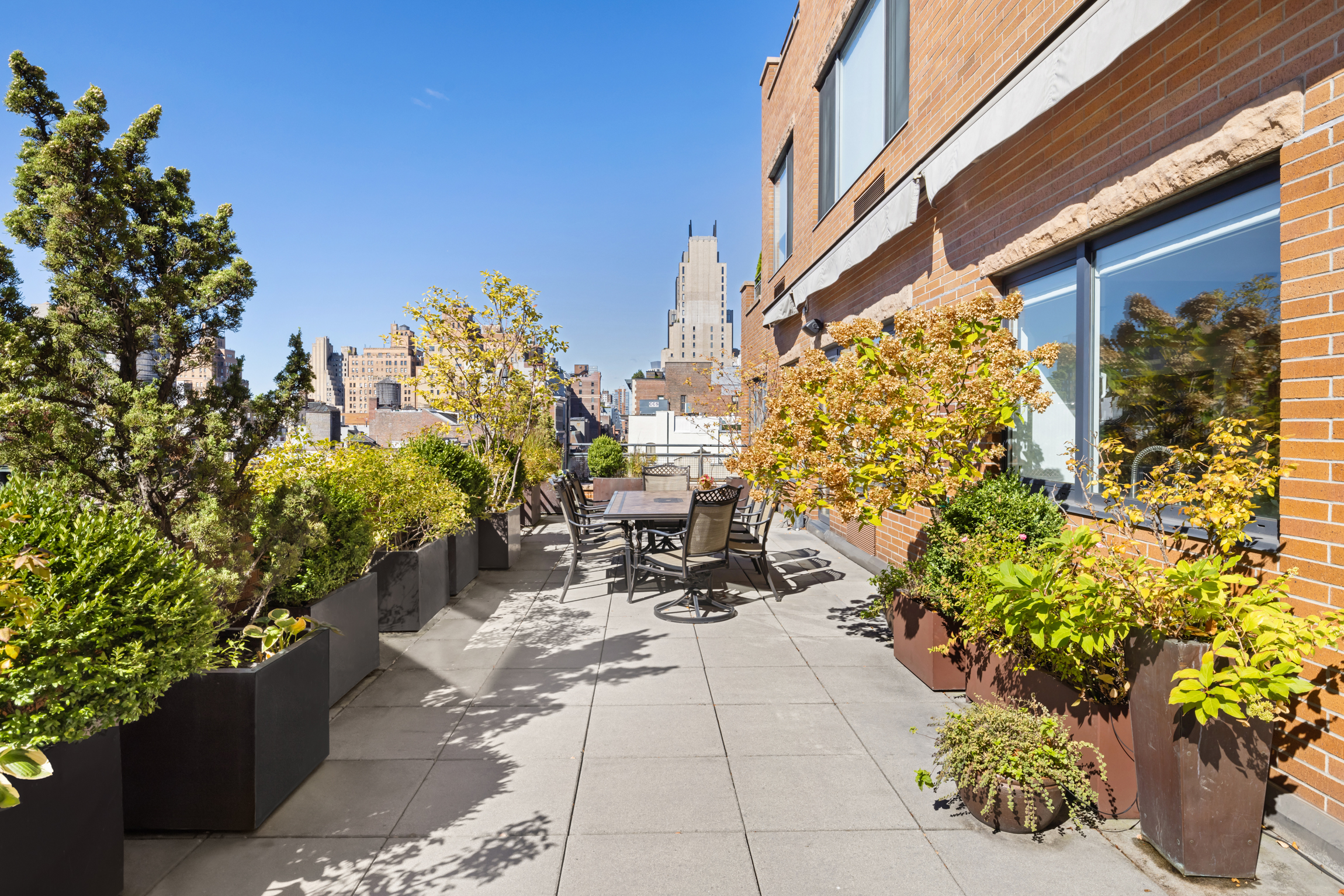 63 West 17th Street, Unit 7A Manhattan, NY 10011 - Photo 8 of 32 a view of a patio with table and chairs and potted plants