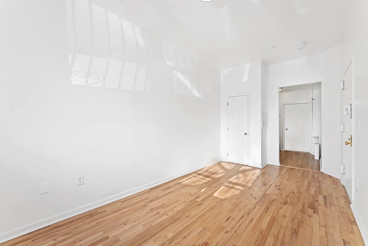 115 South 8th Street, Unit 2 Brooklyn, NY 11249 - Photo 3 of 5 a view of empty room with wooden floor