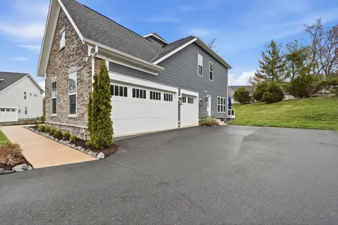 a view of a patio with couches potted plants and wooden floor