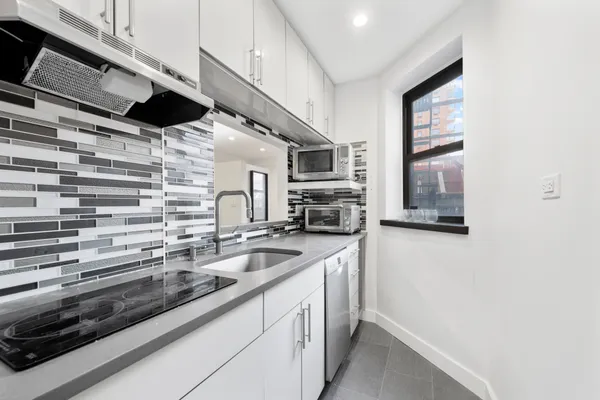 a kitchen with a sink and cabinets