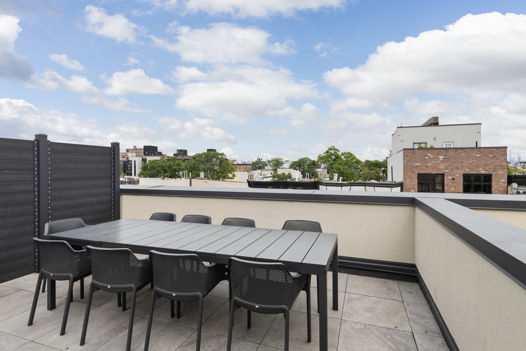 1164 Greene Avenue, Unit PHA Brooklyn, NY 11221 - Photo 12 of 13 a view of dinning table and chairs on roof deck