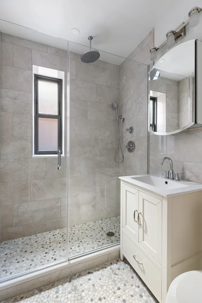 a bathroom with a sink toilet and shower