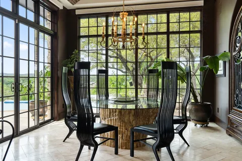 a bedroom with a bed and large windows