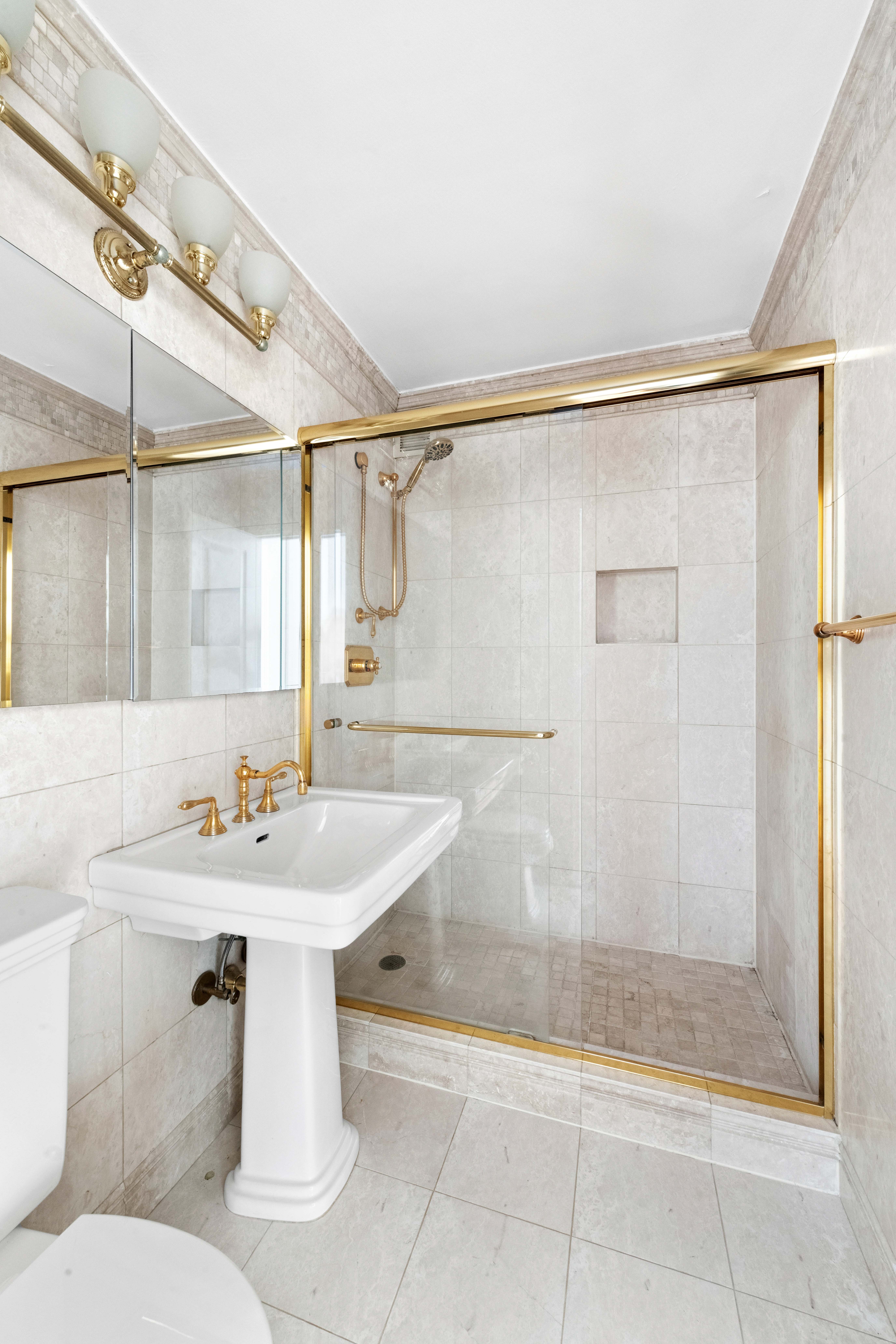 444 East 86th Street, Unit 25EF Manhattan, NY 10028 - Photo 9 of 18 a bathroom with a sink mirror toilet and shower