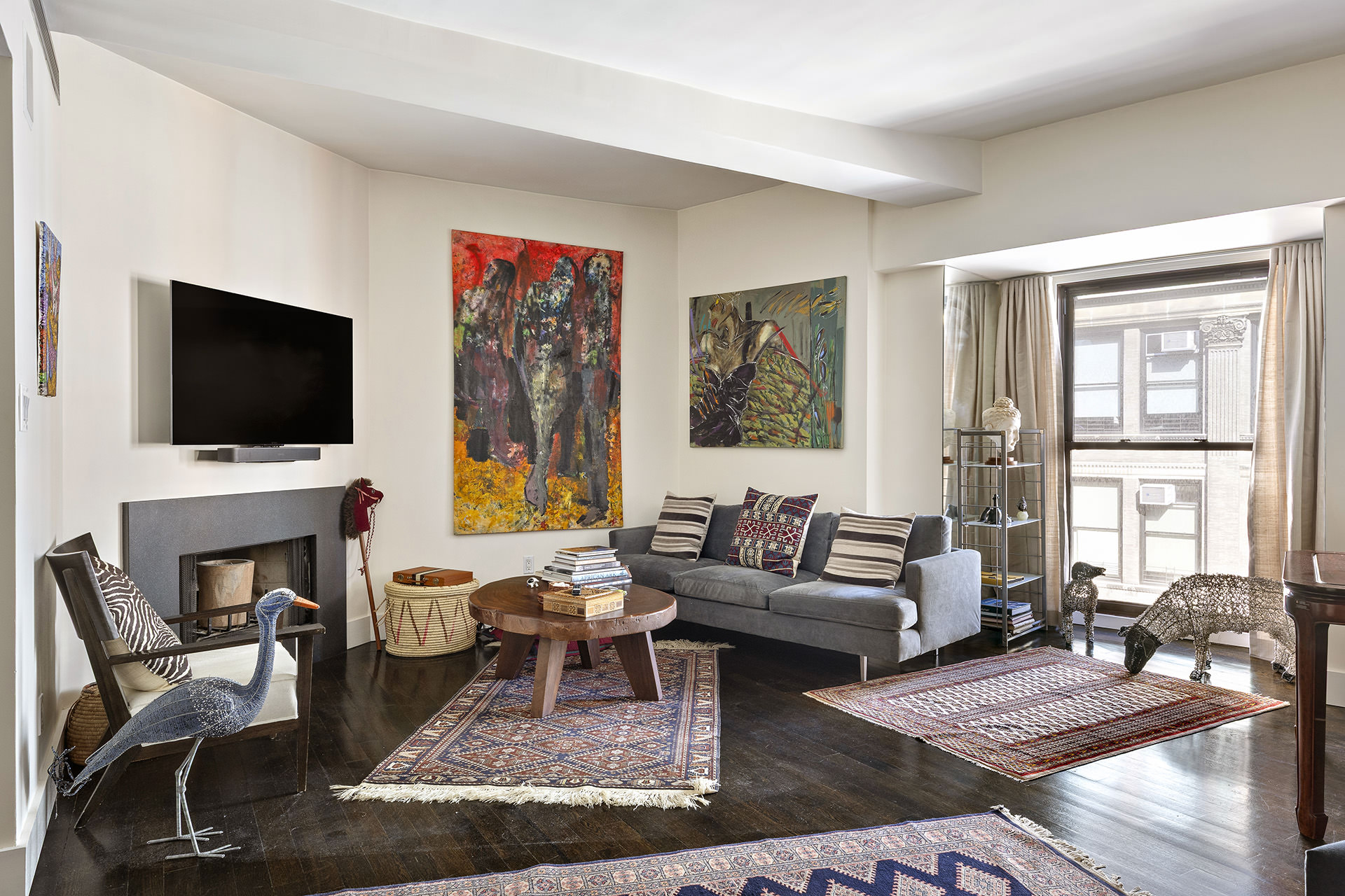 889 Broadway, Unit PHA Manhattan, NY 10003 - Photo 2 of 11 a living room with furniture a flat screen tv and a fireplace