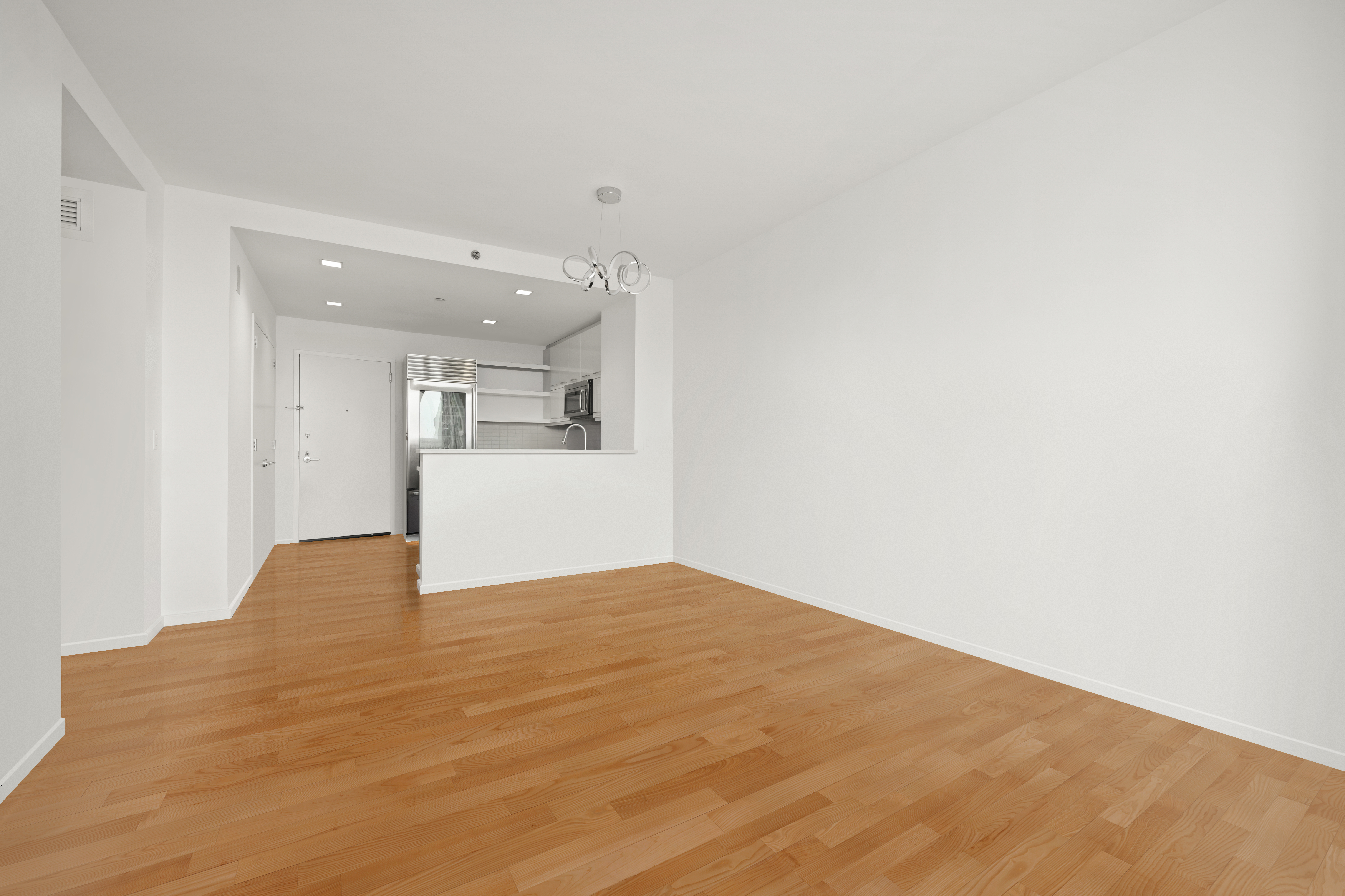 635 West 42nd Street, Unit 12D Manhattan, NY 10036 - Photo 6 of 18 a view of empty room with wooden floor