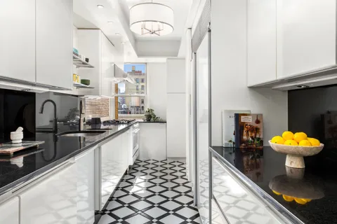 a kitchen with stainless steel appliances kitchen island granite countertop a sink and cabinets