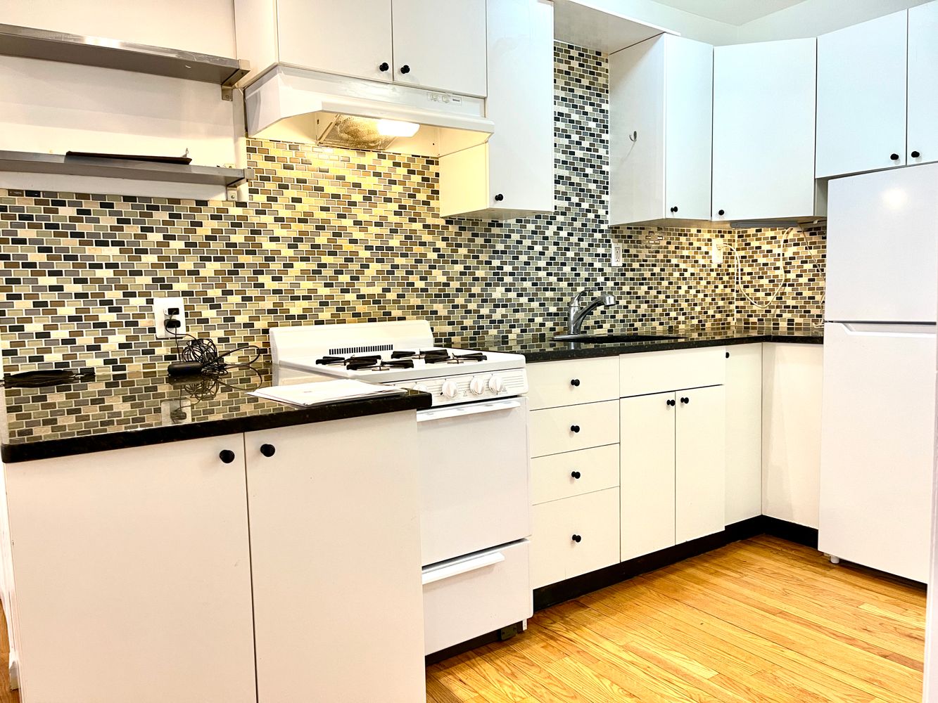 1672 Park Avenue Manhattan, NY 10035 - Photo 14 of 35 a kitchen with white cabinets and white appliances