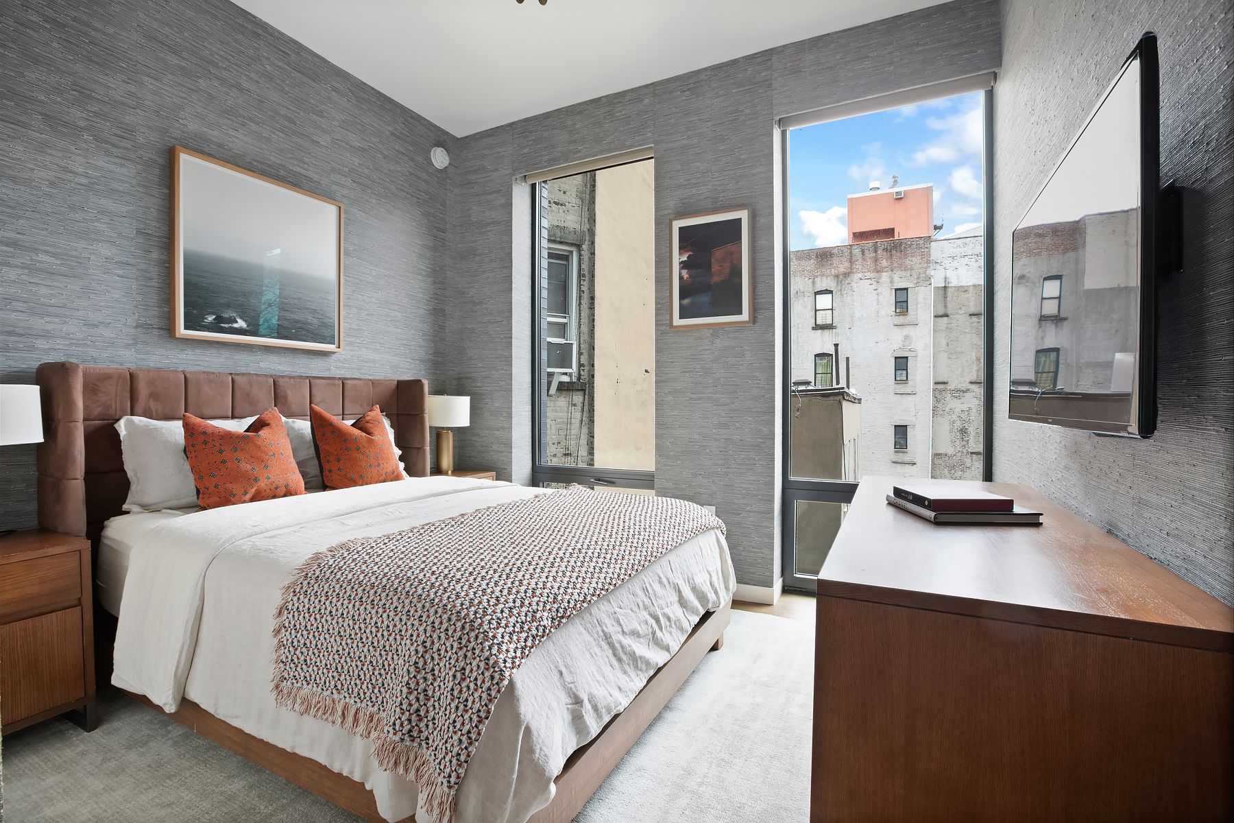 287 East Houston Street, Unit 4C Manhattan, NY 10002 - Photo 5 of 12 a bedroom with bed a night stand and a large window