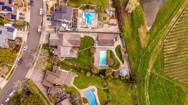 an aerial view of a residential apartment building with a yard