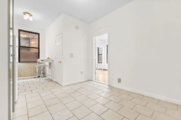 an empty room with cabinet and mirrors