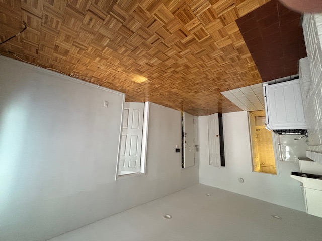 138 East 34th Street, Unit 3F Manhattan, NY 10016 - Photo 3 of 6 a view of a livingroom with wooden floor and a kitchen space
