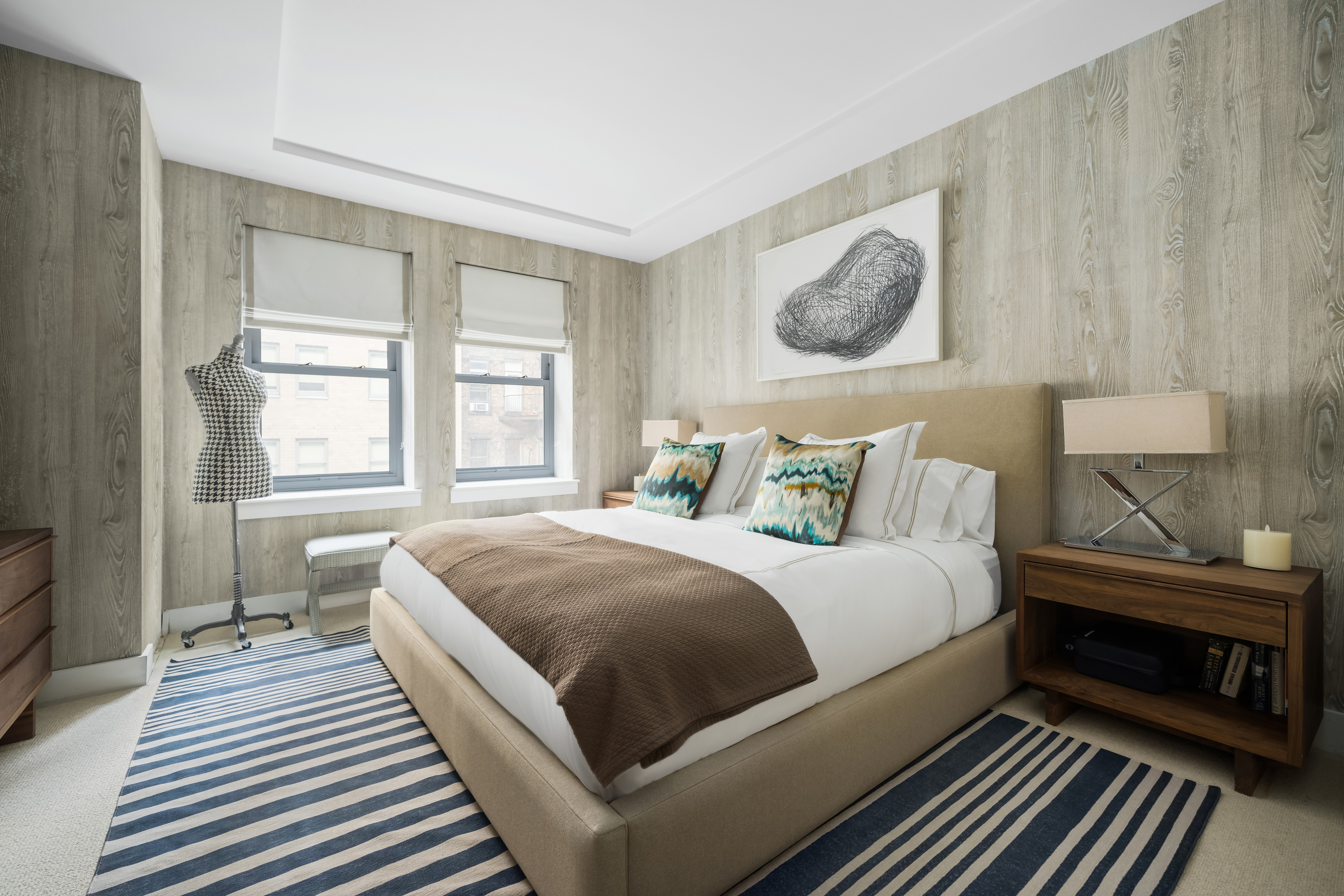92 Greene Street, Unit 3B Manhattan, NY 10012 - Photo 4 of 8 a bedroom with a bed and wooden floor