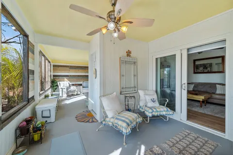 a bedroom with furniture and a large window