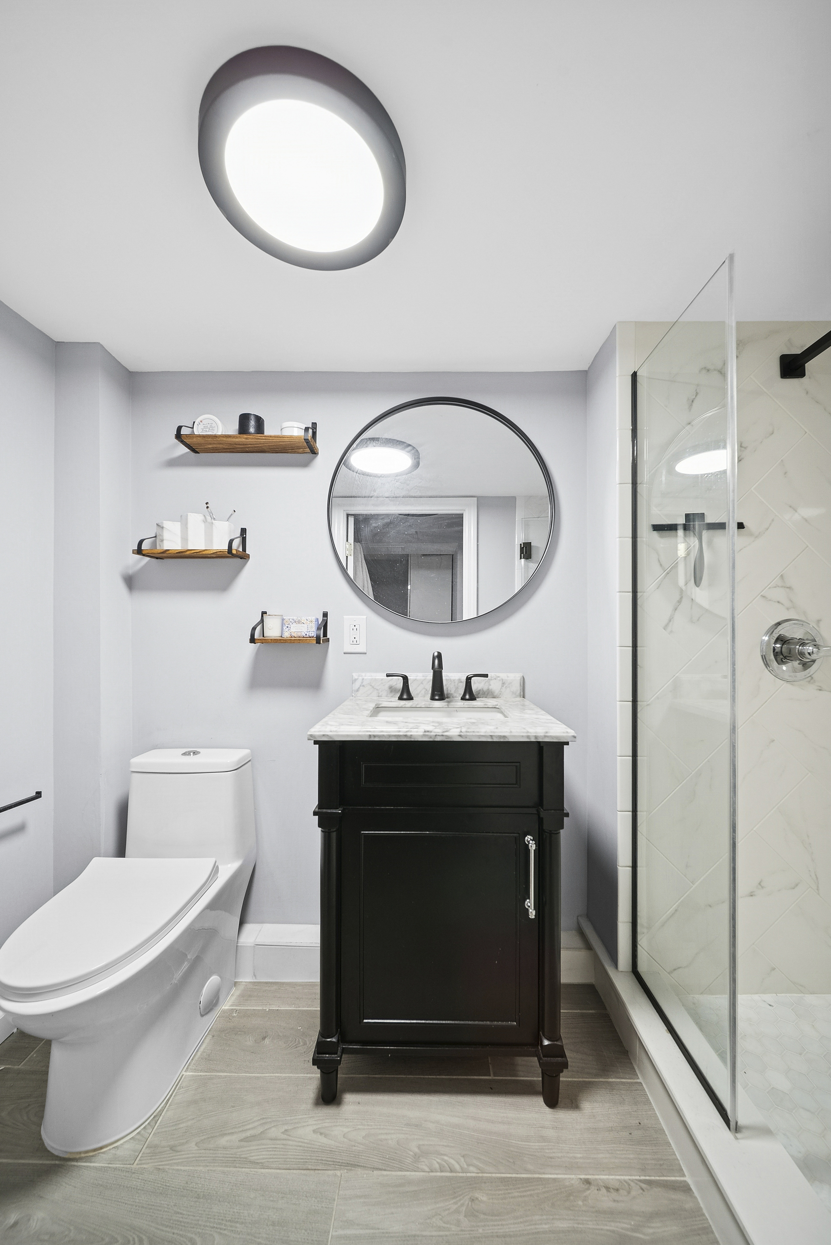 650 88th Street Brooklyn, NY 11228 - Photo 9 of 12 a bathroom with a toilet a sink and mirror