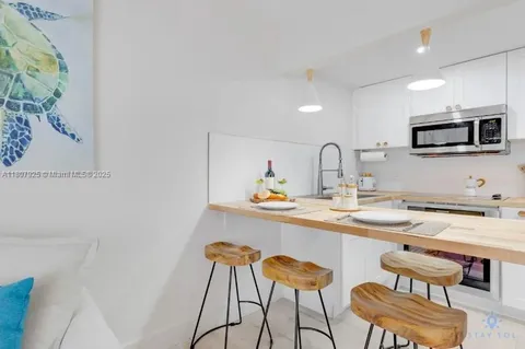 a kitchen with a sink cabinets and microwave