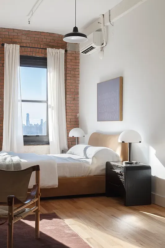 a bedroom with a bed and a table