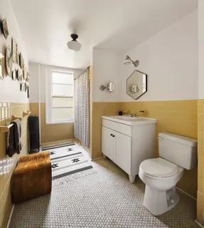 a picture of a bathroom with a window