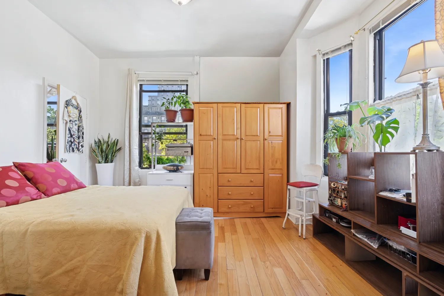 a bedroom with a bed and wooden floor