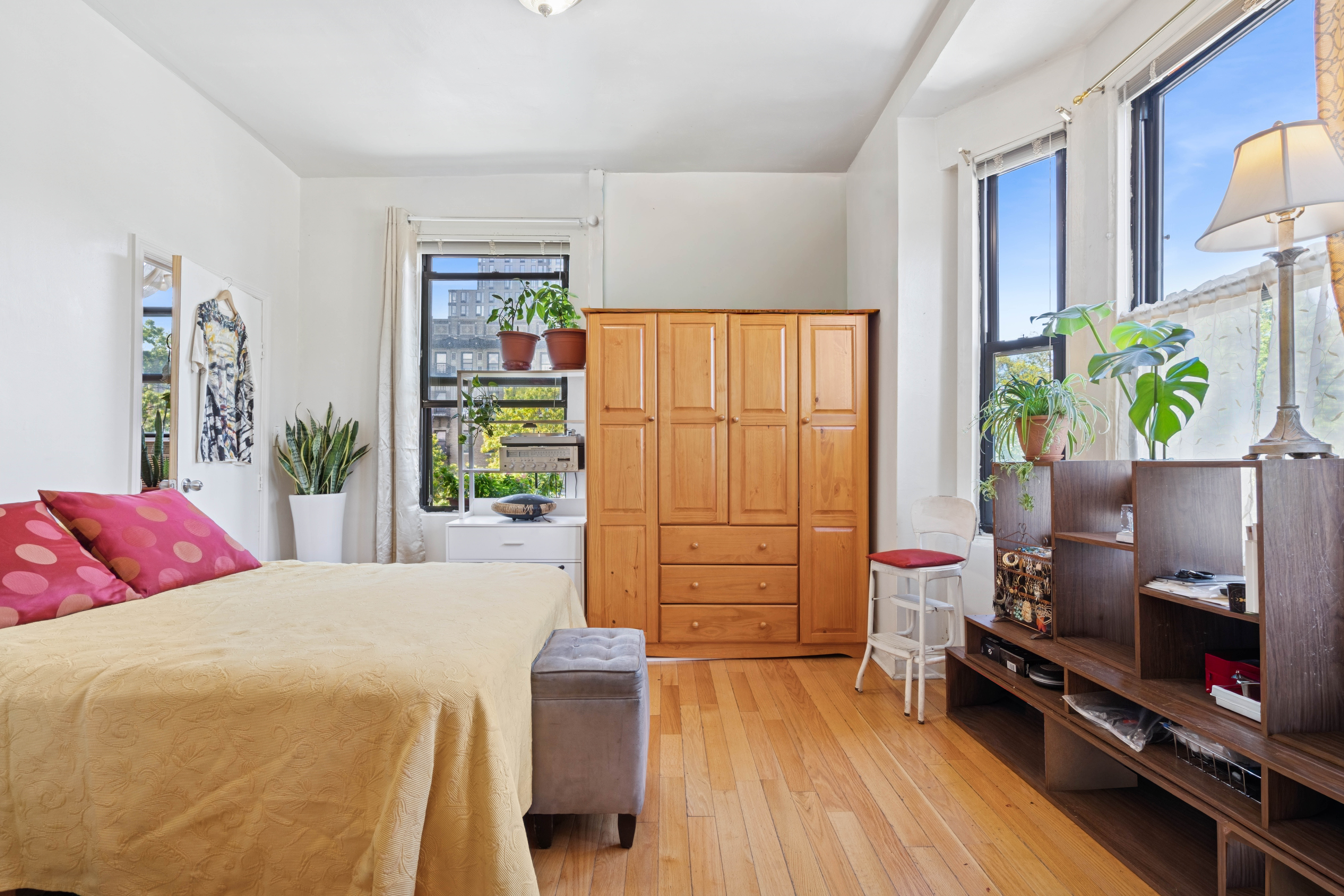 550 West 153rd Street, Unit 34 Manhattan, NY 10031 - Photo 1 of 8 a bedroom with a bed and wooden floor