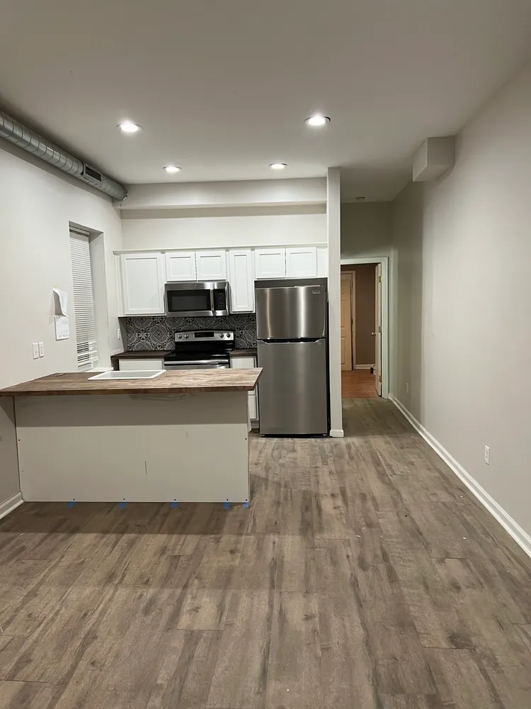 a large kitchen with kitchen island a cabinetry and stainless steel appliances
