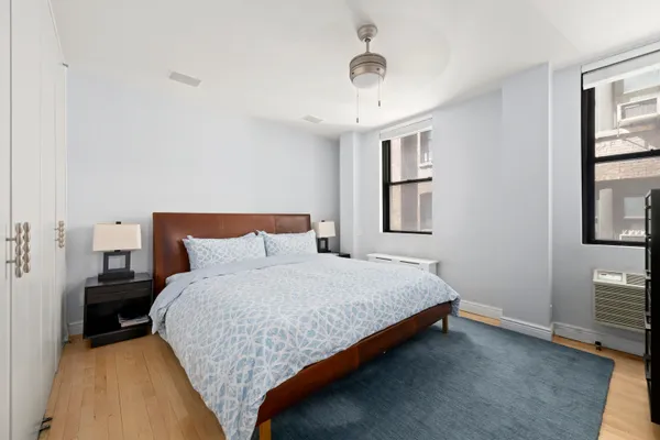 a bedroom with a bed and a night stand