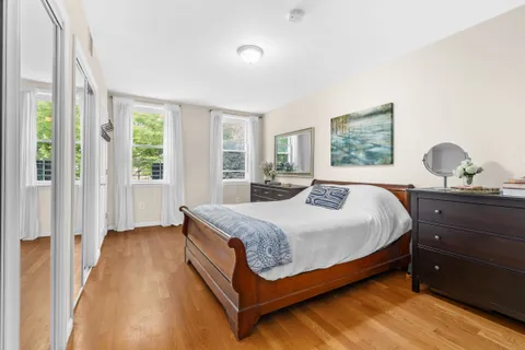 a bedroom with a bed window and couch