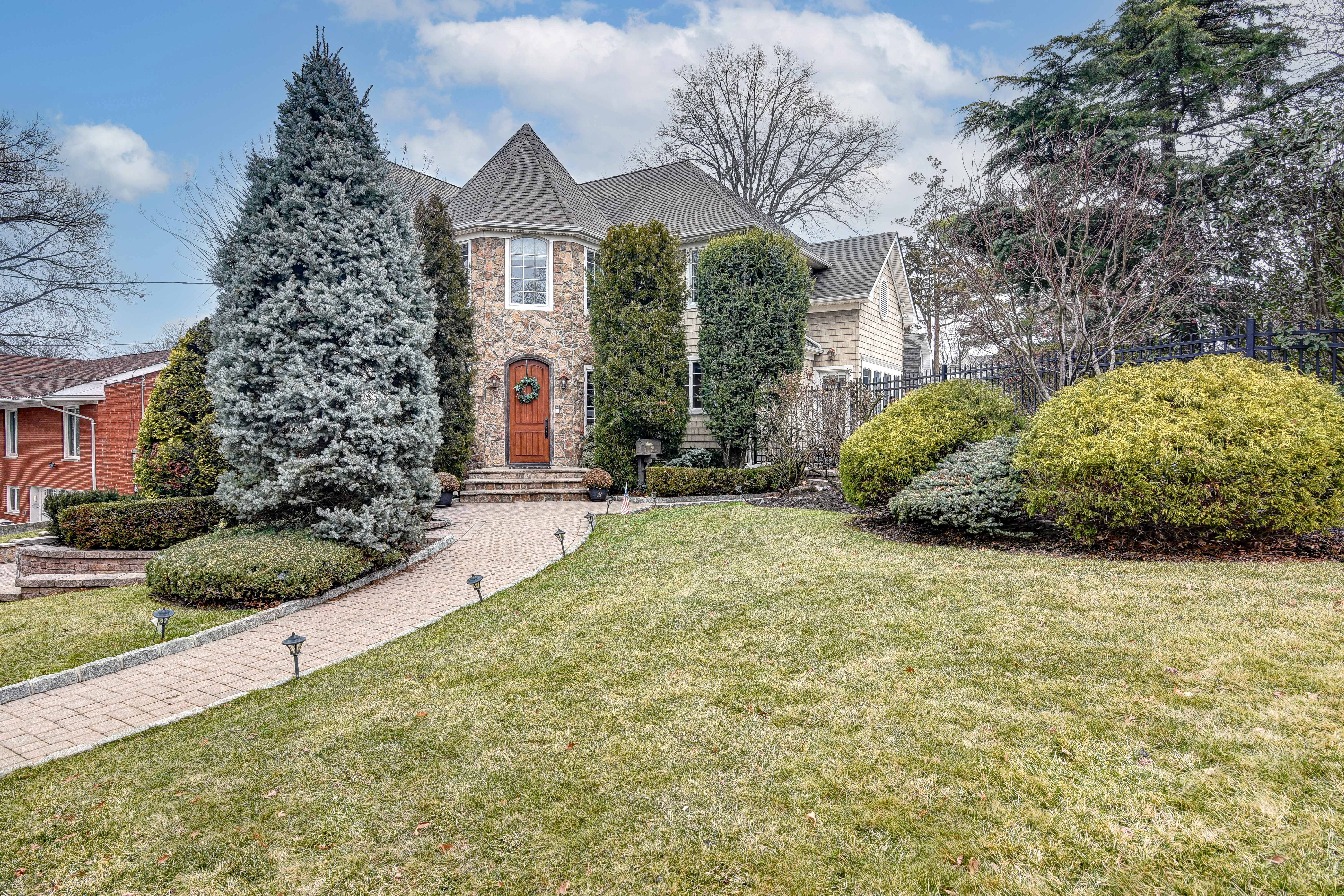 a front view of a house with a garden