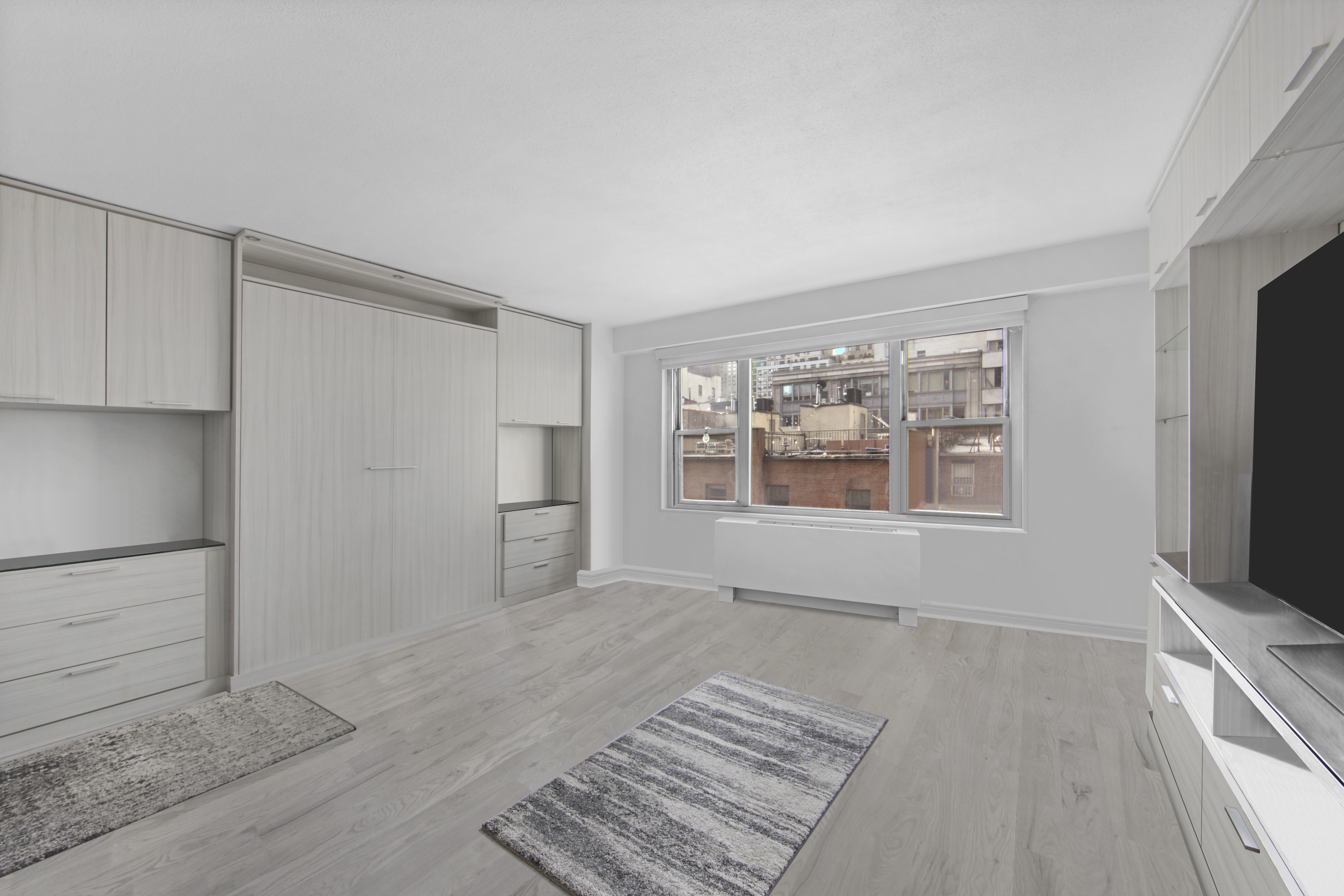 220 East 60th Street, Unit 5F Manhattan, NY 10022 - Photo 2 of 8 a view of an empty room with a fireplace and a window