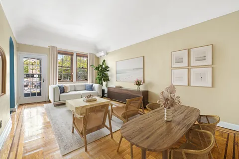 a living room with fireplace furniture and two windows