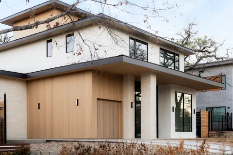 a living room with furniture a table and a large window