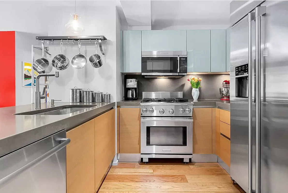 2280 Frederick Douglass Boulevard, Unit 6C Manhattan, NY 10027 - Photo 3 of 7 a kitchen with stainless steel appliances a stove a microwave and a refrigerator