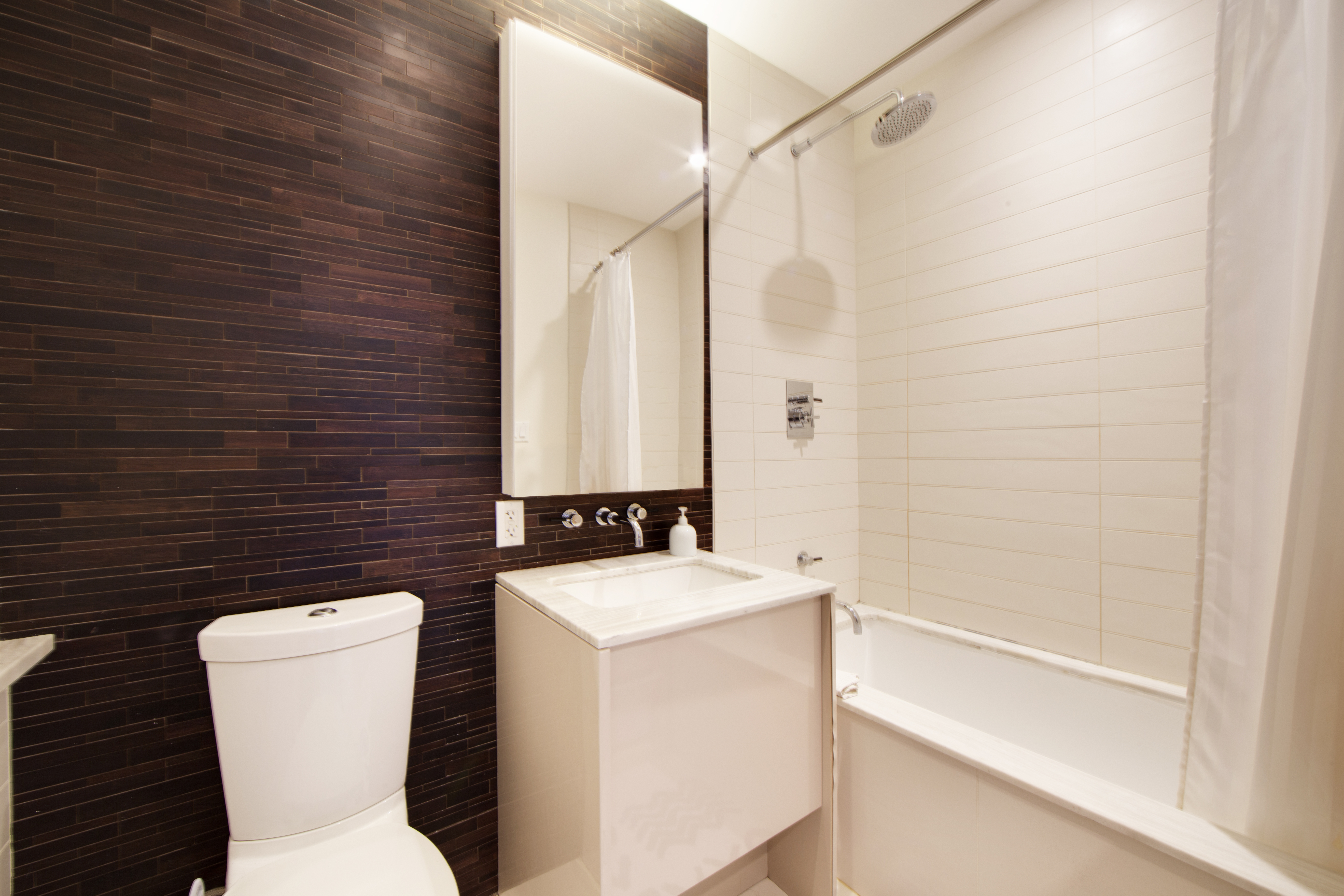 2 Northside Piers, Unit 2O Brooklyn, NY 11249 - Photo 6 of 7 a bathroom with a toilet sink and mirror