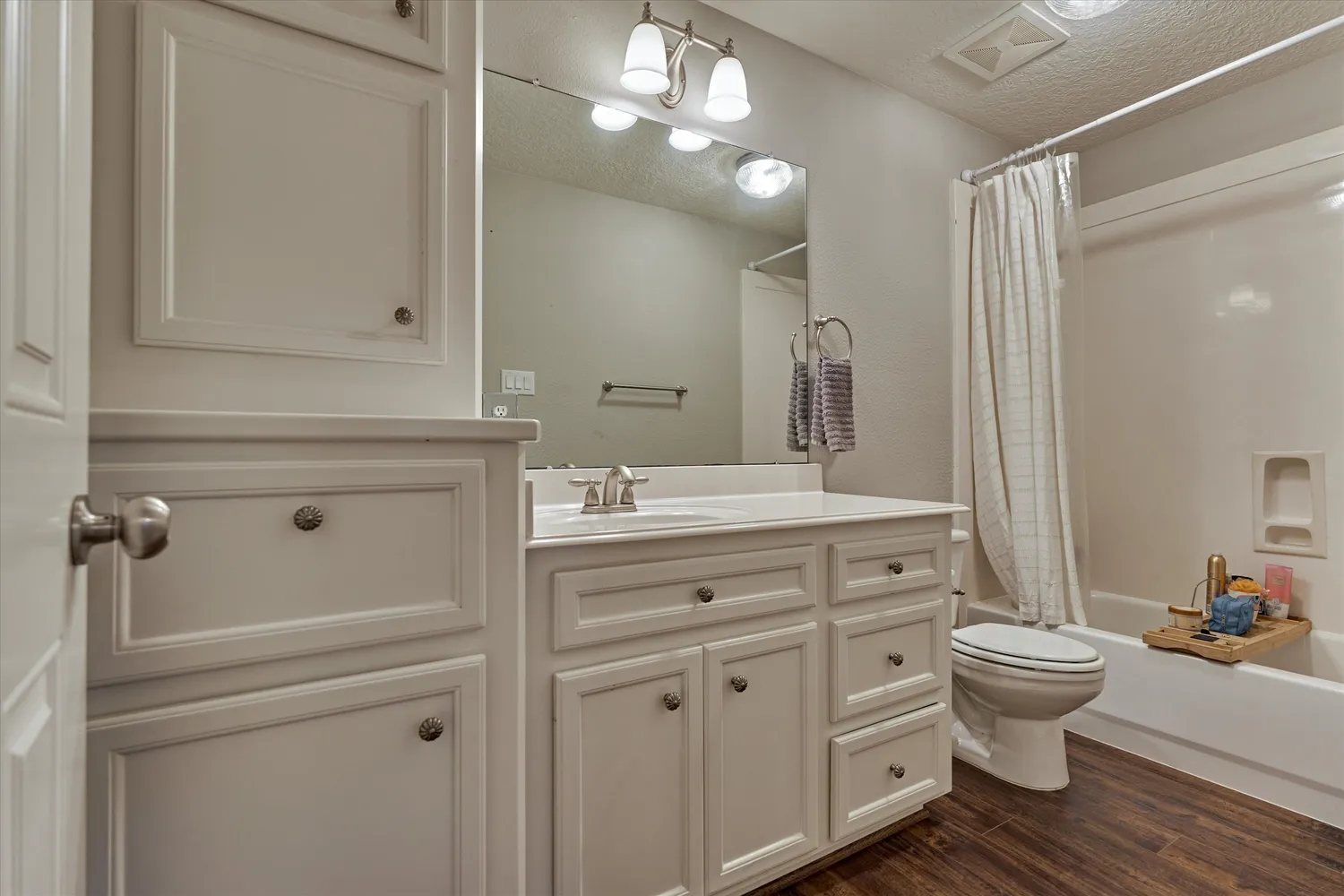 a bathroom with a double vanity sink mirror and toilet