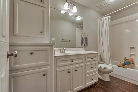 a bathroom with a double vanity sink mirror and toilet
