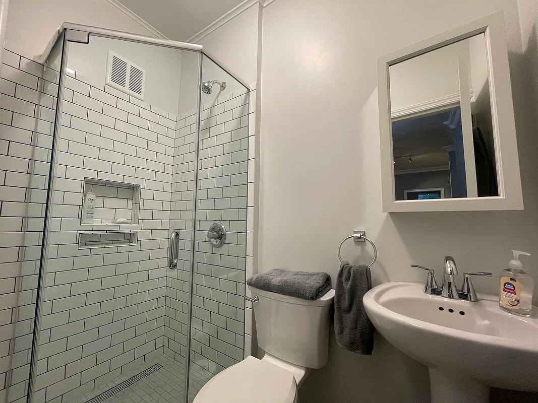 317 East 73rd Street, Unit 1RE Manhattan, NY 10021 - Photo 4 of 9 a bathroom with a sink a toilet and mirror